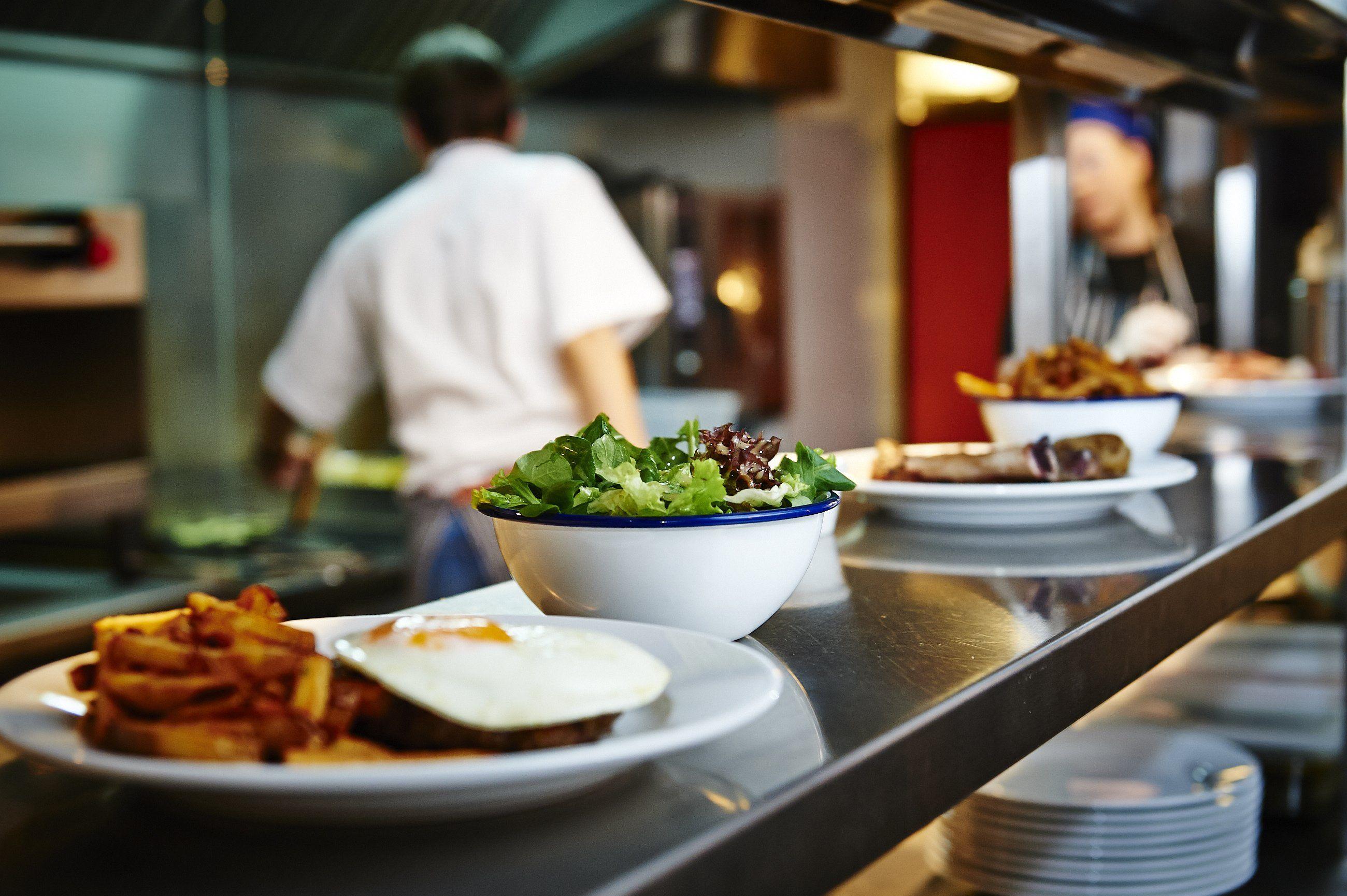 Picture of a Few Plates on the Counter Awaiting Departure to Their Respective Tables